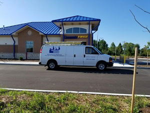 j & j electrical truck in front of a bank